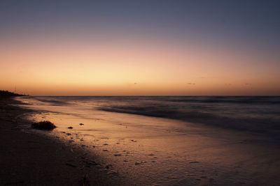 Scenic view of sea against clear sky during sunset