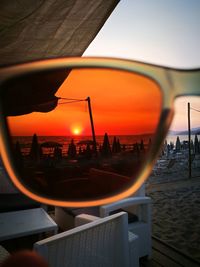 Close-up of beach against sky during sunset