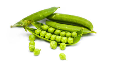 High angle view of green beans against white background