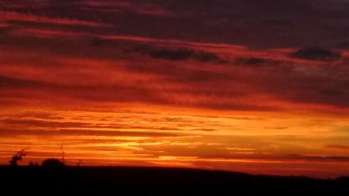 Silhouette landscape against dramatic sky