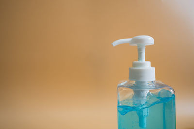 Close-up of water bottle against blue background