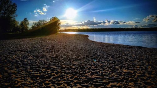 Scenic view of beach against sky during sunset