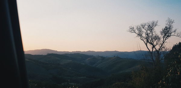 Scenic view of mountains against clear sky during sunset