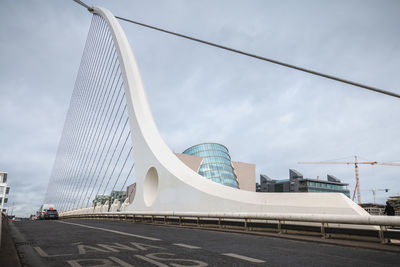 Low angle view of bridge against cloudy sky