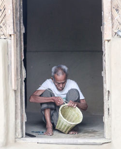 Full length of man making basket