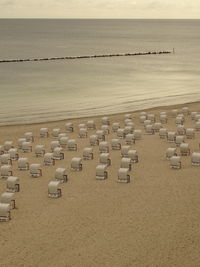 High angle view of chairs on beach against sky