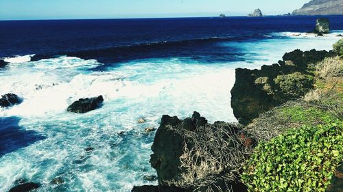 Scenic view of sea against blue sky