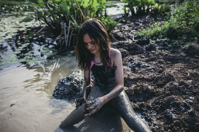 Young girl playing in the mud in queensland australia