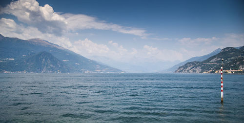 Scenic view of sea and mountains against sky