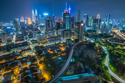 High angle view of illuminated buildings in city at night