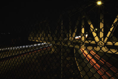 Illuminated chainlink fence at night