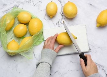 Ripe yellow lemons on a white wooden board, ingredient for lemonade, top view