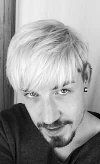 Close-up portrait of man by wall