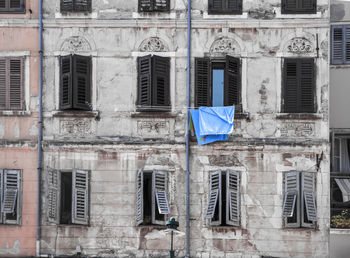 Low angle view of clothes drying on old building