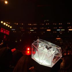 Rear view of woman with umbrella at night