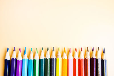 Close-up of colored pencils against white background