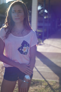 Portrait of smiling young woman standing outdoors