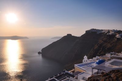 High angle view of sea and buildings against sky during sunset