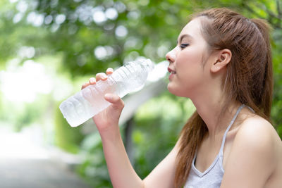 Portrait of a woman drinking water