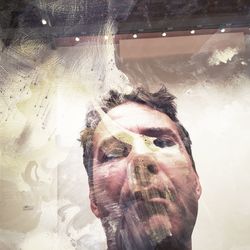 Young man with reflection on sunny day