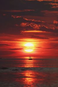 Scenic view of sea against romantic sky at sunset