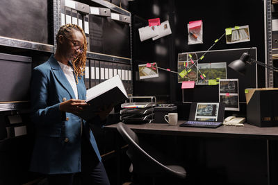 Rear view of man using digital tablet in office