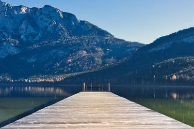 Pier over lake against mountains