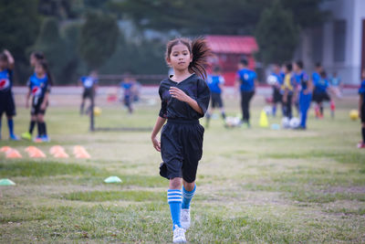 Full length of woman running on field