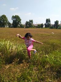 Full length of girl on field