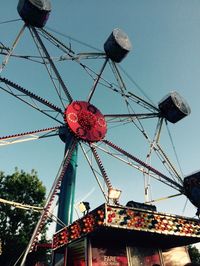 Low angle view of ferris wheel against blue sky