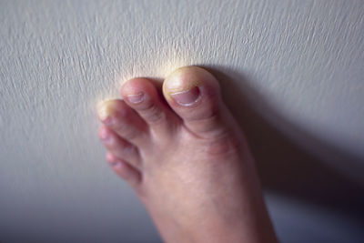 Close-up of human foot touching wall