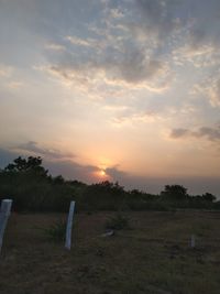 Scenic view of field against sky during sunset