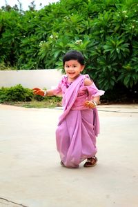 Happy girl standing on pink dress/saree