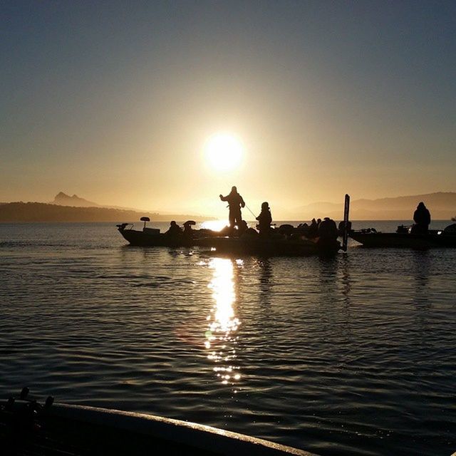 water, sunset, silhouette, sea, sun, nautical vessel, transportation, scenics, mode of transport, boat, tranquil scene, reflection, clear sky, waterfront, tranquility, beauty in nature, nature, sky, sunlight, idyllic