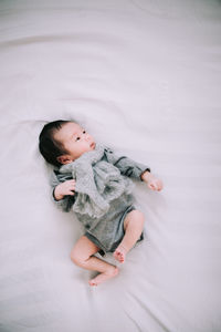 High angle view of baby sleeping on bed