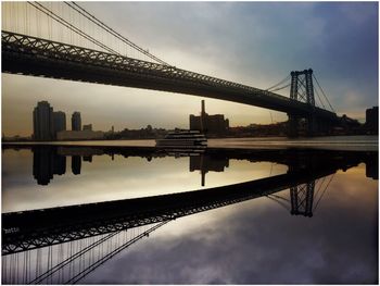 Bridge over river with city in background