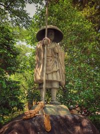 Statue against trees and plants