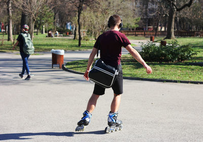 Rear view of boy playing on soccer field