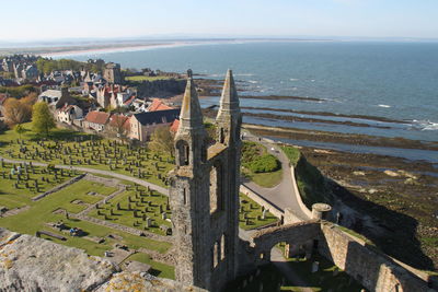 High angle view of buildings and sea against sky