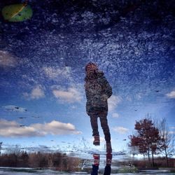 Silhouette of woman standing against sky