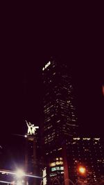 Low angle view of modern building against sky at night