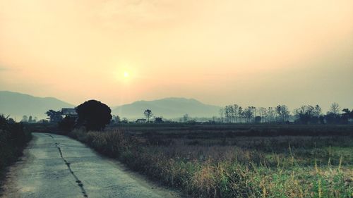 Scenic view of field against sky during sunset