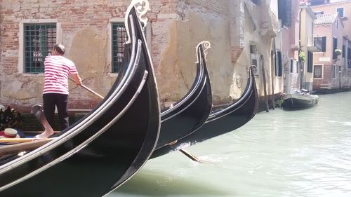 Man sailing gondola on canal