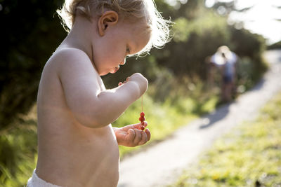 Toddler holding wild strawberries