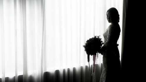 Portrait of bride standing in dark room