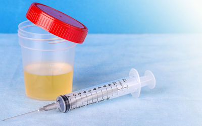 Close-up of syringe and medicine on table