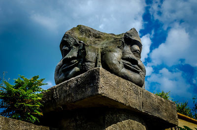 Low angle view of statue against cloudy sky