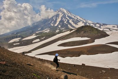 Man on snowcapped mountain against sky