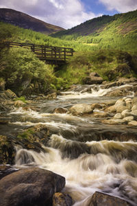 Scenic view of stream flowing through rocks