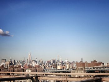 View of cityscape against clear blue sky